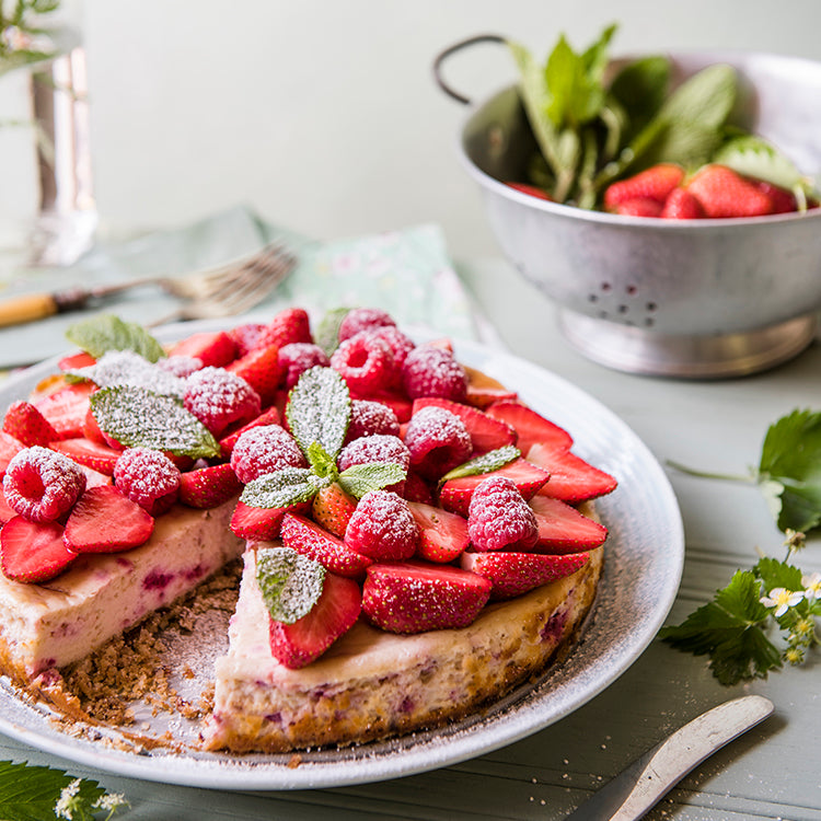 Cheesecake made from quinoa flakes, topped with rasberries and icing sugar