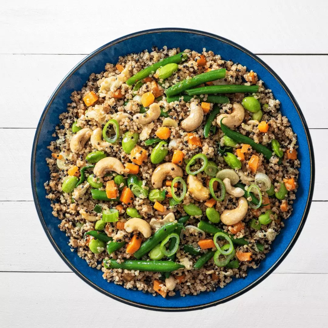 bowl of egg fried quinoa with peanuts
