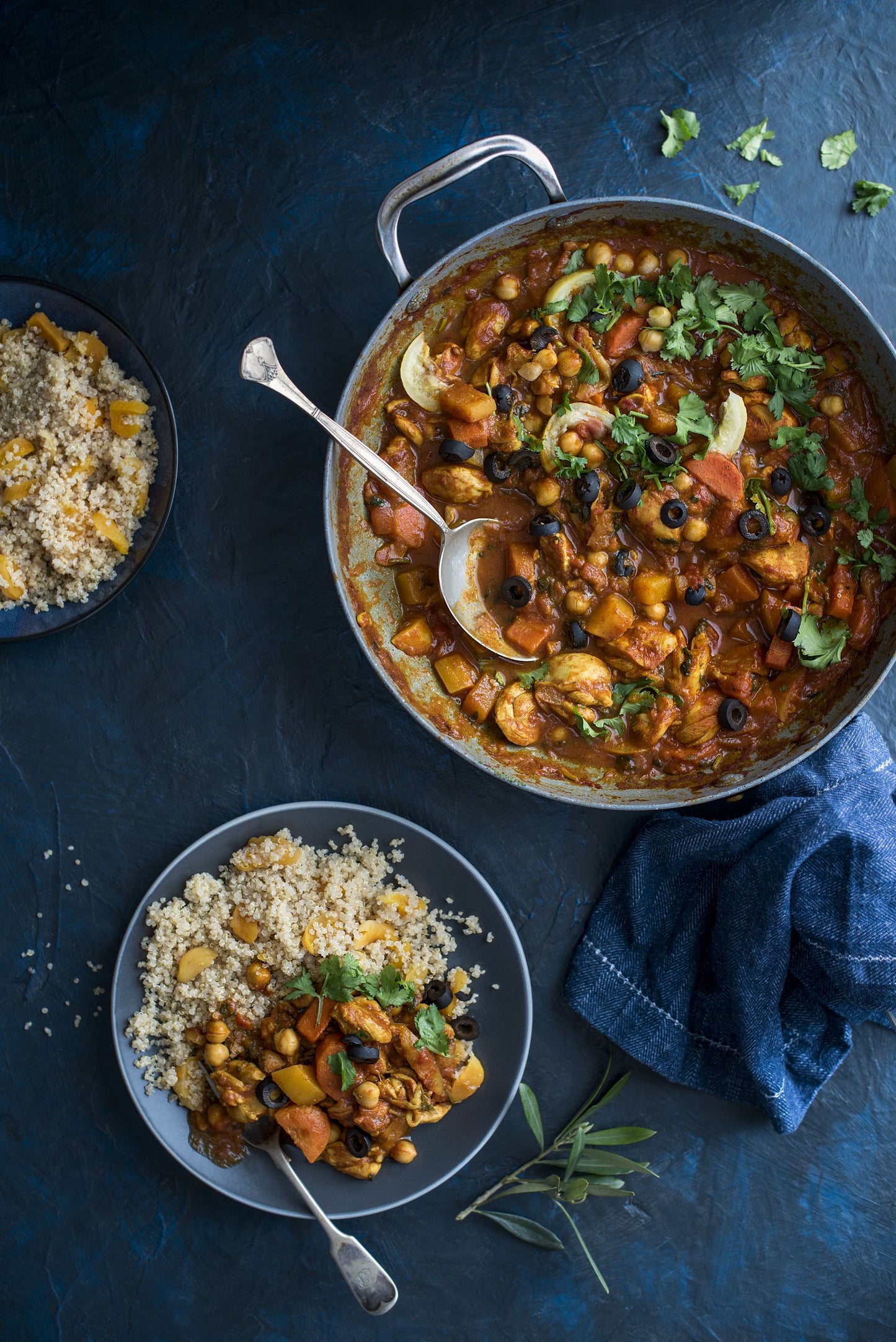 Pan of chicken Tagine next to a bowl of quinoa