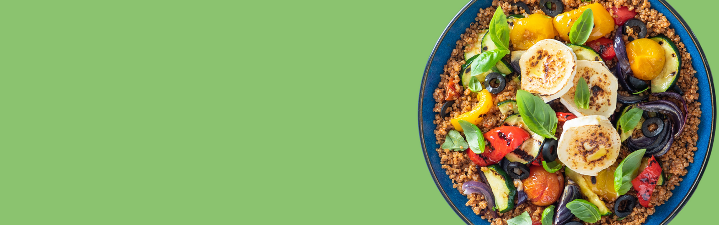blue bowl of quinoa and colourful roasted vegetables