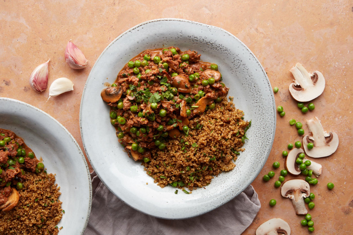 Plate of quinoa and stroganoff with mushrooms halved on the side