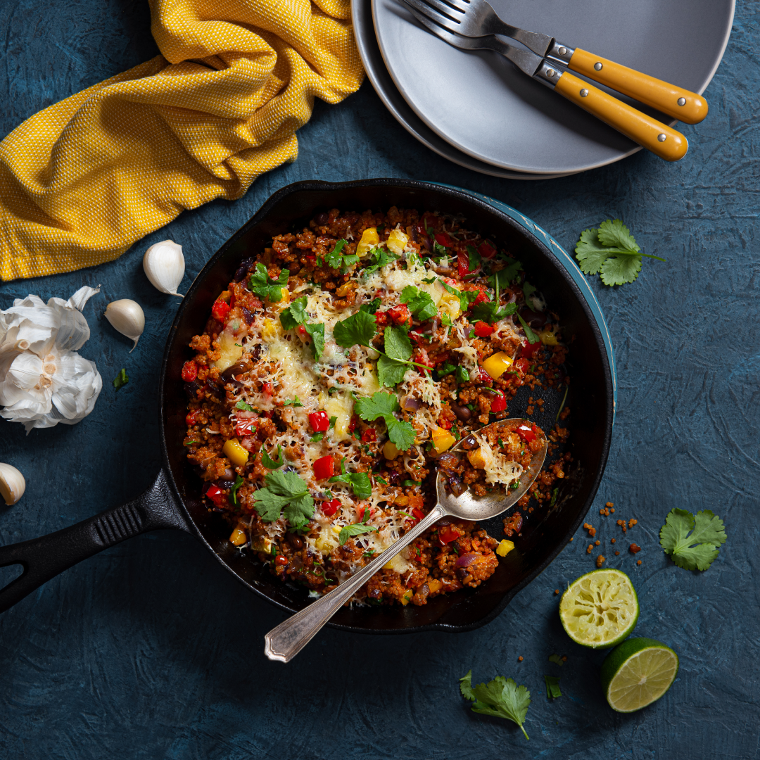 pan with Spanish style quinoa, beans and melted cheese