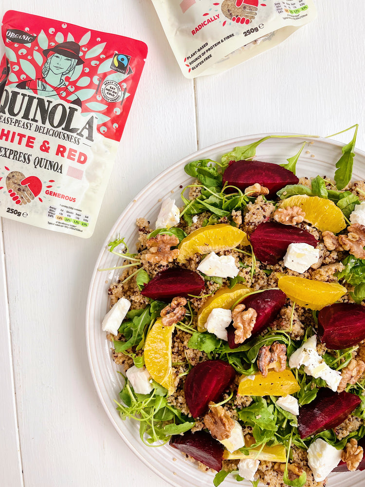 Plate of quinoa, beetroot and orange salad with a packet of quinola on the side 