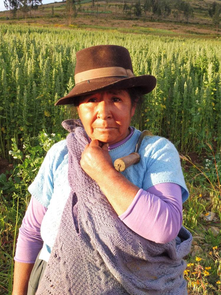 Peruvian Farmer stood in front of quinoa field 