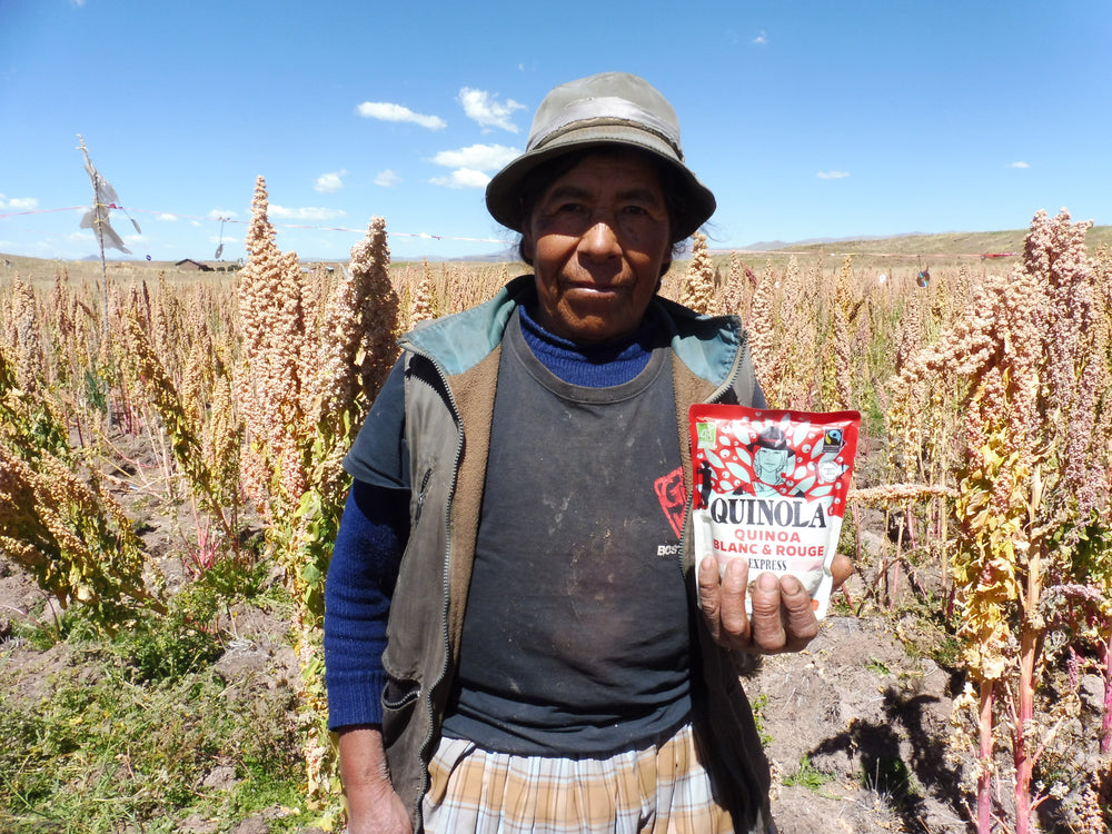 Farmer holding a pack of quinola quinoa 