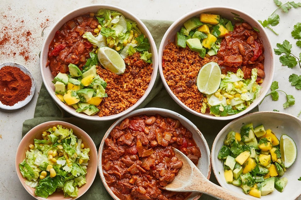 bowls of vegan chilli and quinoa salad
