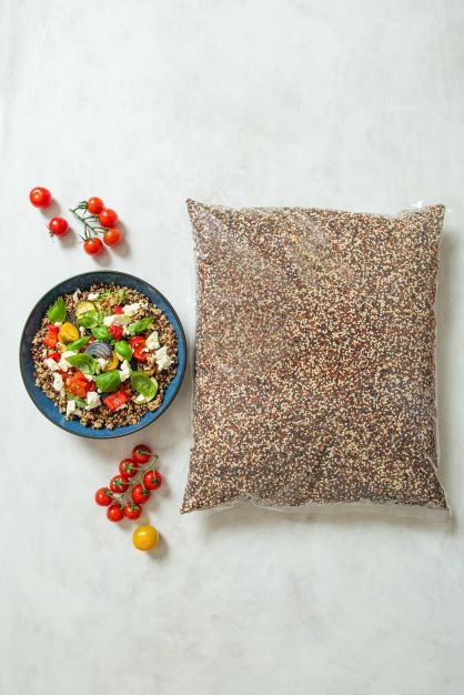 large pack of quinoa next to a bowl of quinoa salad