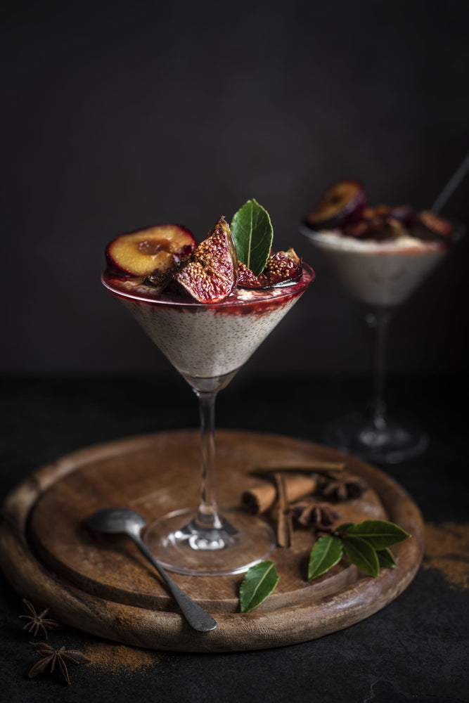 Flute with creamy quinoa pudding topped with figs and a mint leaf